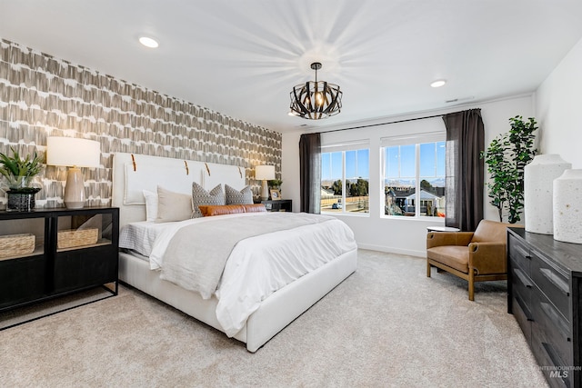 bedroom featuring light carpet and a chandelier