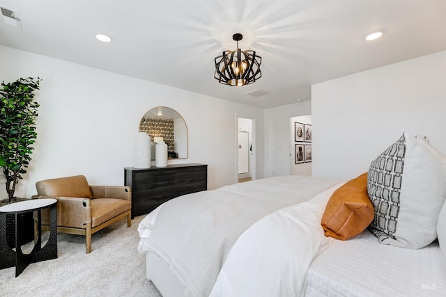 carpeted bedroom with a notable chandelier