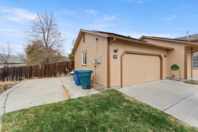 view of property exterior with a garage and a yard