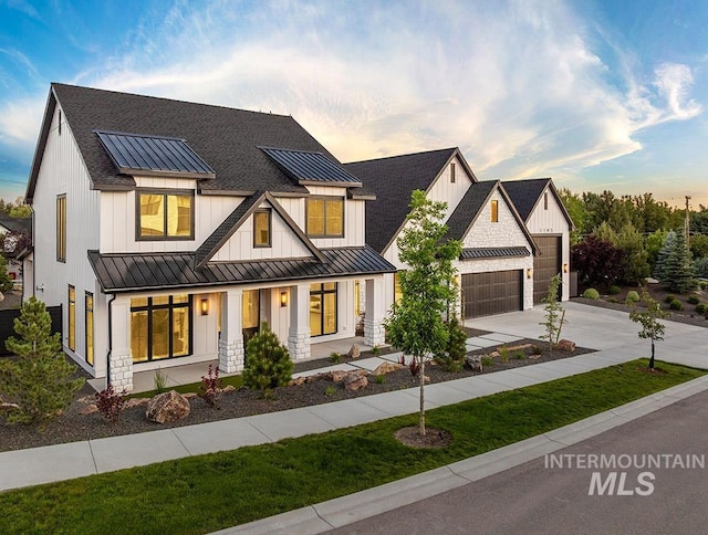 1195 N Arrano Farms Ln, Eagle, ID 83616 - modern farmhouse style home featuring a standing seam roof, a porch, metal roof, driveway, and a shingled roof