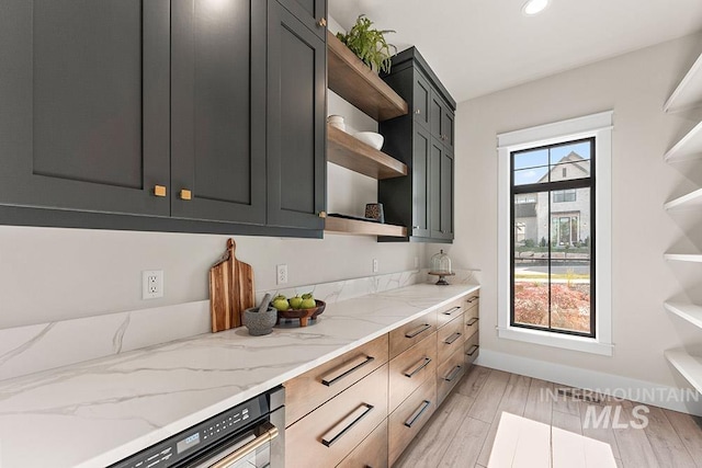 1195 N Arrano Farms Ln, Eagle, ID 83616 - kitchen featuring open shelves, light stone counters, recessed lighting, and light wood-style floors