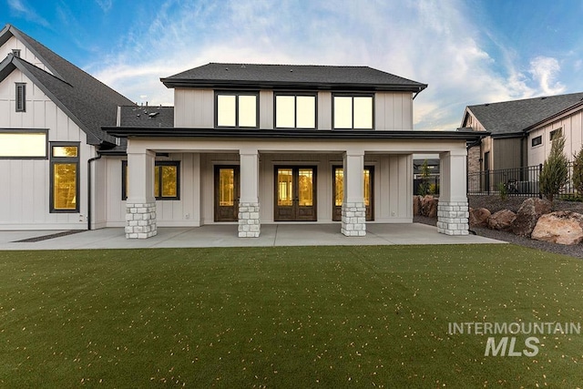 1195 N Arrano Farms Ln, Eagle, ID 83616 - back of property with board and batten siding, french doors, a patio area, and a shingled roof