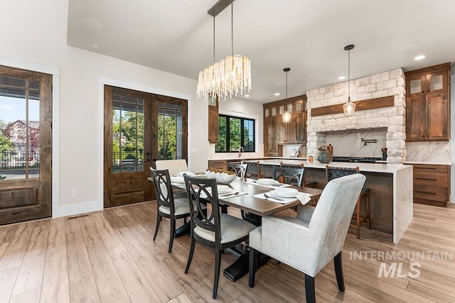 1195 N Arrano Farms Ln, Eagle, ID 83616 - dining area featuring light wood-style flooring, a chandelier, recessed lighting, baseboards, and french doors