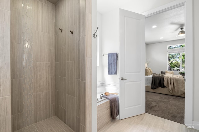 ensuite bathroom with a bath, a ceiling fan, ensuite bath, and a tile shower