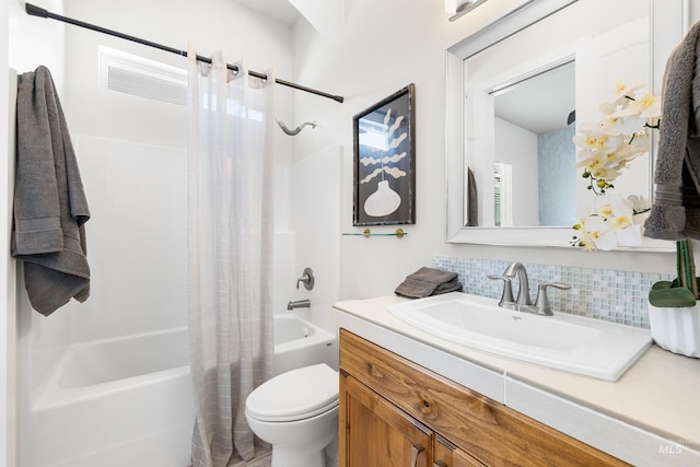 bathroom with backsplash, toilet, shower / bathtub combination with curtain, and vanity