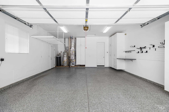 garage featuring water heater and a garage door opener