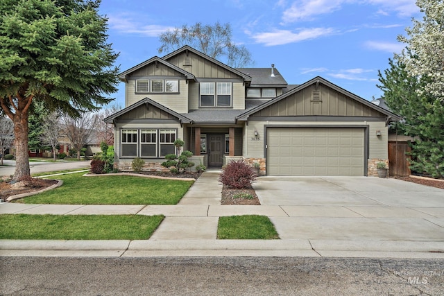 craftsman house featuring a front yard, stone siding, a garage, board and batten siding, and concrete driveway