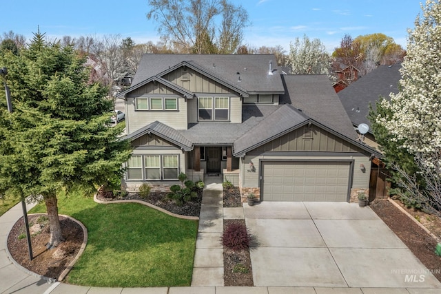 craftsman-style home with a shingled roof, an attached garage, board and batten siding, a front lawn, and driveway