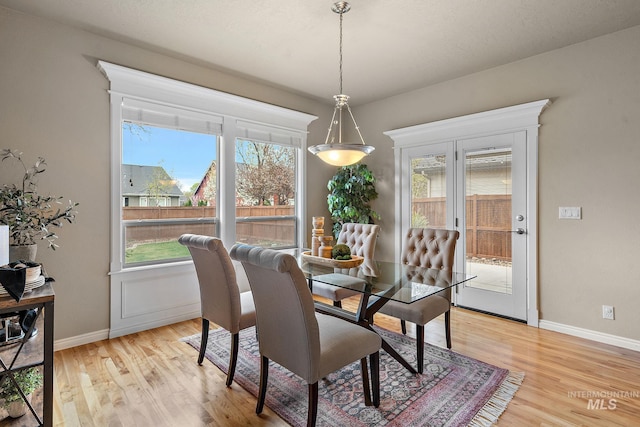 dining room featuring baseboards and light wood-style floors