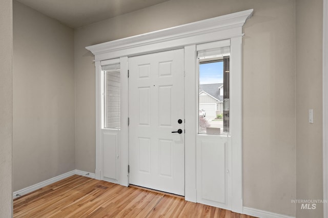 entrance foyer with light wood-style flooring and baseboards