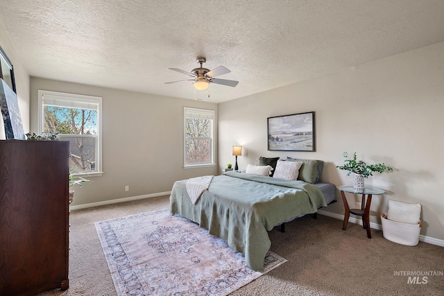bedroom with ceiling fan, baseboards, multiple windows, and carpet