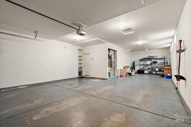 garage with baseboards and a garage door opener