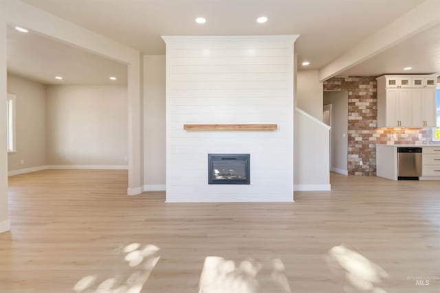4320 SW 2nd Ave, New Plymouth, ID 83655 - unfurnished living room with light wood finished floors, recessed lighting, and a large fireplace