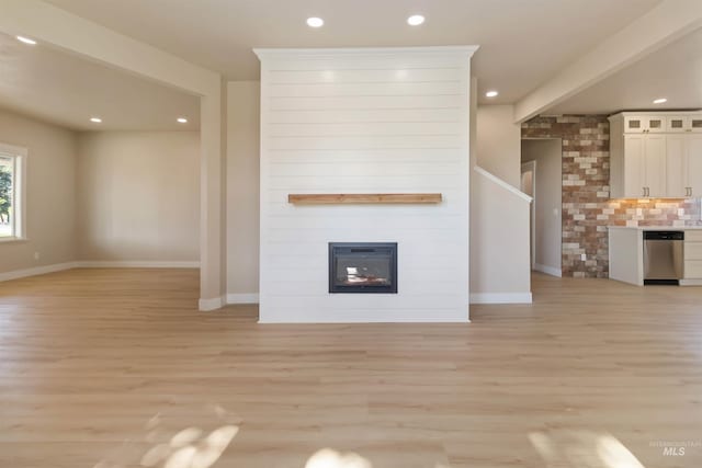 4320 SW 2nd Ave, New Plymouth, ID 83655 - unfurnished living room featuring light wood-style flooring, a large fireplace, and recessed lighting