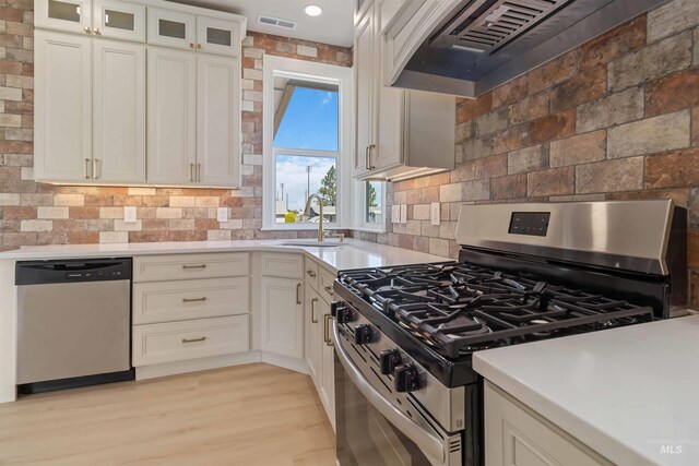 4320 SW 2nd Ave, New Plymouth, ID 83655 - kitchen with stainless steel appliances, custom exhaust hood, white cabinetry, and tasteful backsplash