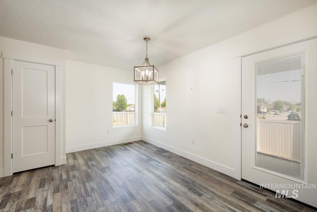 interior space with dark hardwood / wood-style floors and a notable chandelier