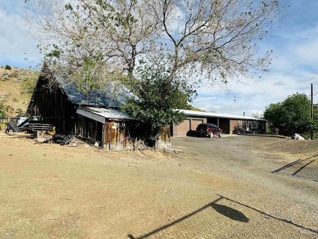 245 W 3rd St, Huntington, OR 97907 - view of outbuilding with driveway and a carport
