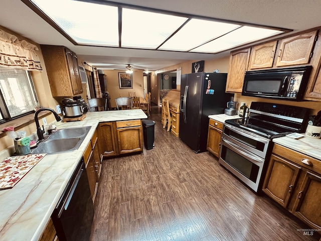245 W 3rd St, Huntington, OR 97907 - kitchen featuring black appliances, a sink, a peninsula, light countertops, and dark wood-style floors