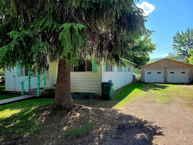 102 N Hornet Creek Rd, Council, ID 83612 - view of home's exterior with a detached garage, an outbuilding, driveway, and a lawn
