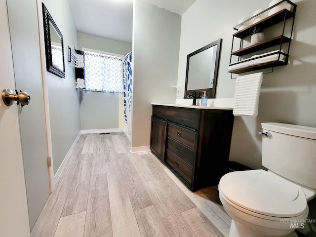 102 N Hornet Creek Rd, Council, ID 83612 - full bathroom featuring wood finished floors, vanity, toilet, and baseboards