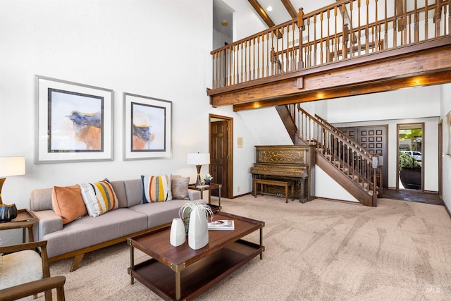 carpeted living room with stairs and a high ceiling