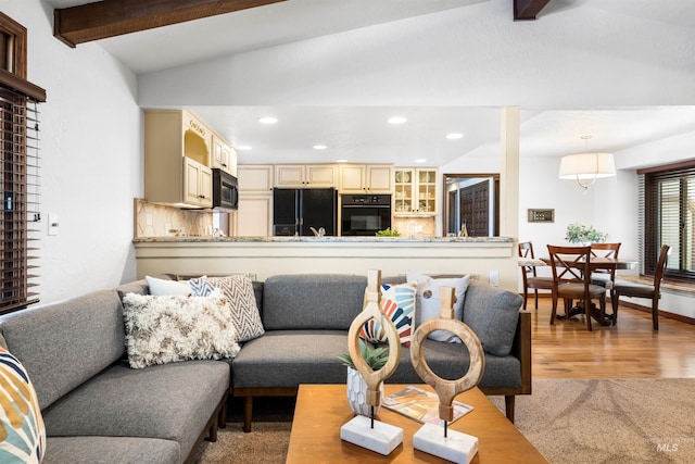 living room with light wood-type flooring and recessed lighting