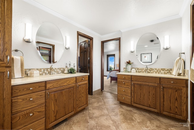 full bathroom featuring ornamental molding, two vanities, ensuite bathroom, and baseboards