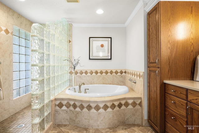 bathroom featuring a walk in shower, a bath, crown molding, and tile patterned floors