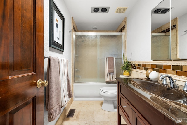 full bath with vanity, toilet, and combined bath / shower with glass door