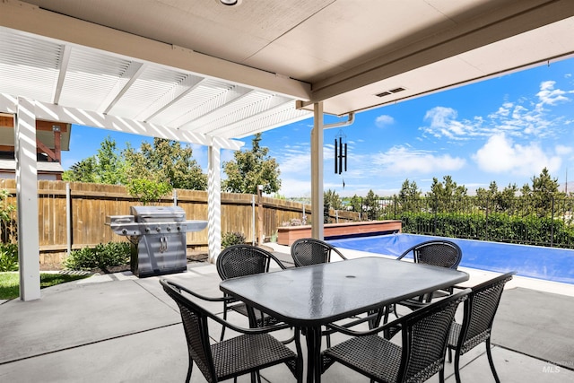 view of patio with a pergola, a grill, outdoor dining space, and a fenced backyard