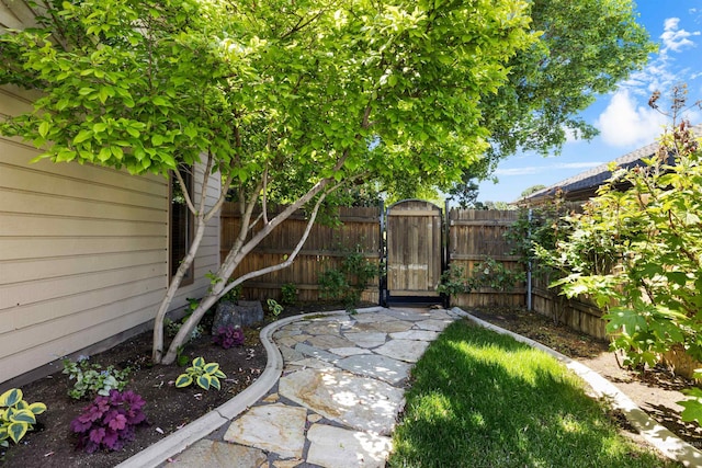 fenced backyard with a gate
