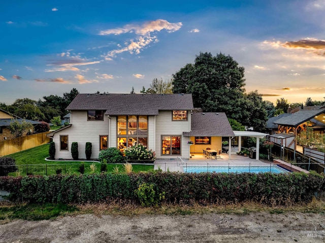 rear view of house with a fenced backyard and a patio area