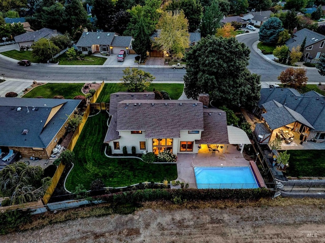 aerial perspective of suburban area featuring a pool