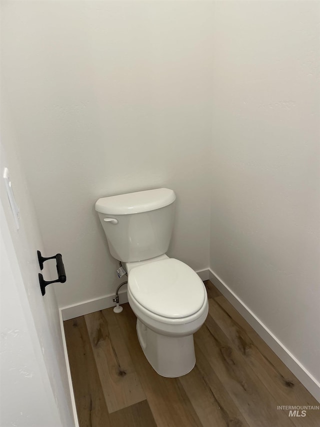 1207 Frank Henry Rd, Twin Falls, ID 83301 - bathroom with wood finished floors, toilet, and baseboards