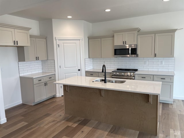 1207 Frank Henry Rd, Twin Falls, ID 83301 - kitchen featuring appliances with stainless steel finishes, a sink, light stone counters, wood finished floors, and recessed lighting