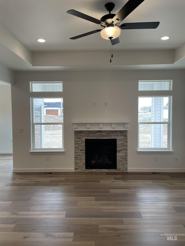 1207 Frank Henry Rd, Twin Falls, ID 83301 - unfurnished living room featuring baseboards, a ceiling fan, wood finished floors, and a fireplace