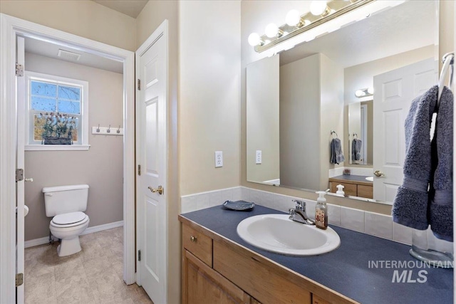 bathroom featuring vanity and toilet