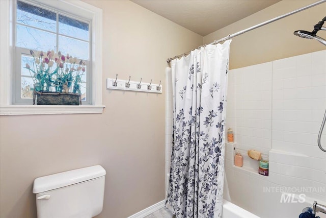 bathroom with toilet and shower / bath combo