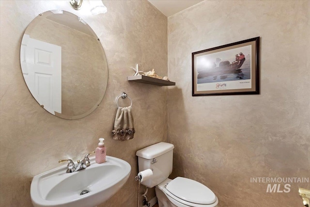 bathroom with toilet and sink