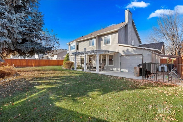 rear view of property featuring a yard, a pergola, and a patio