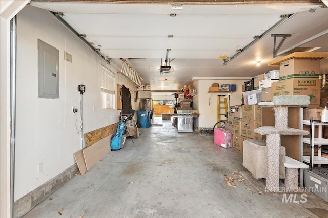 garage with a garage door opener and electric panel