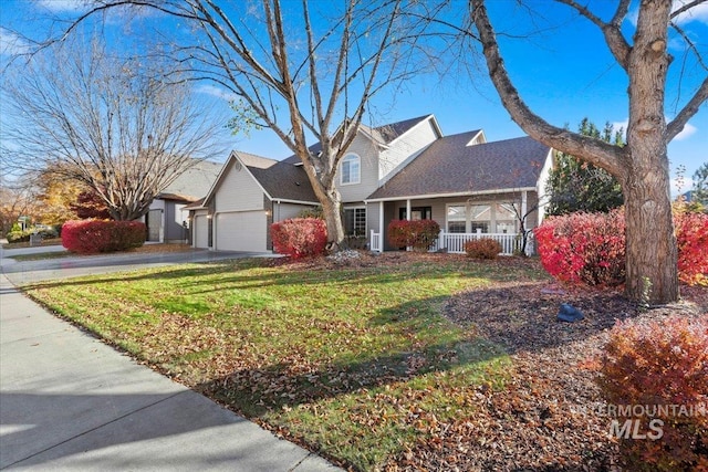 front facade featuring a garage, a front yard, and covered porch