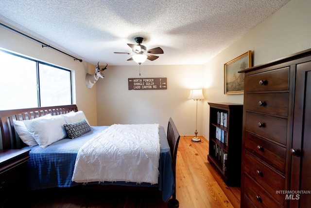 1955 E Parkside Dr, Boise, ID 83712 - bedroom with light wood-type flooring, a textured ceiling, and a ceiling fan
