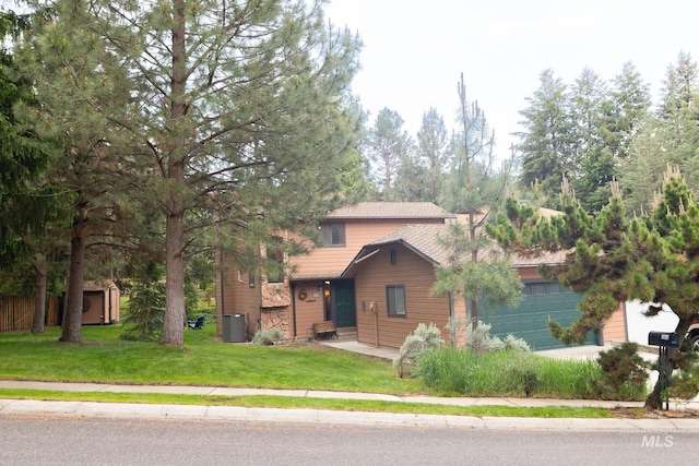 1955 E Parkside Dr, Boise, ID 83712 - view of front facade featuring cooling unit, a front yard, a storage shed, and a garage
