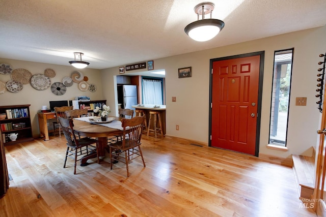 1955 E Parkside Dr, Boise, ID 83712 - dining room with light wood finished floors and a textured ceiling