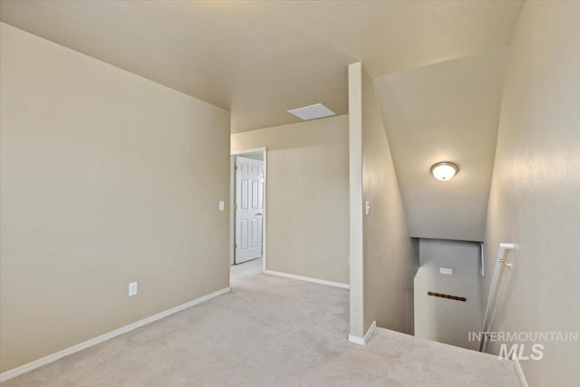 hallway featuring carpet and baseboards