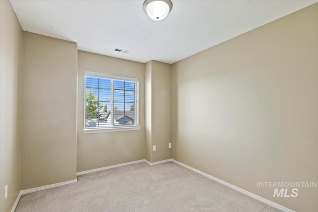 carpeted spare room with baseboards