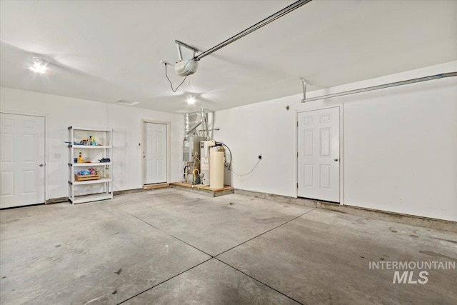 garage with a garage door opener and water heater