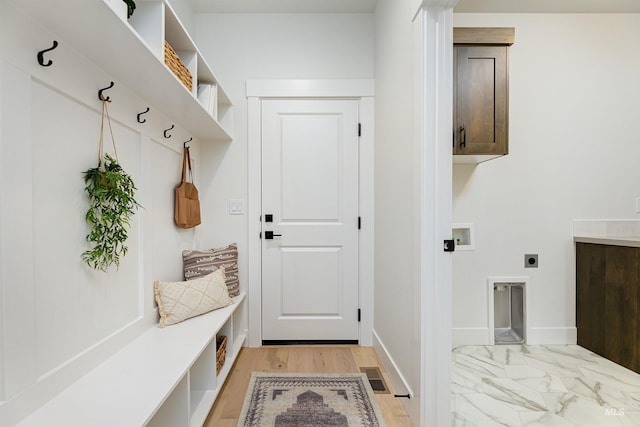 mudroom featuring visible vents, marble finish floor, and baseboards