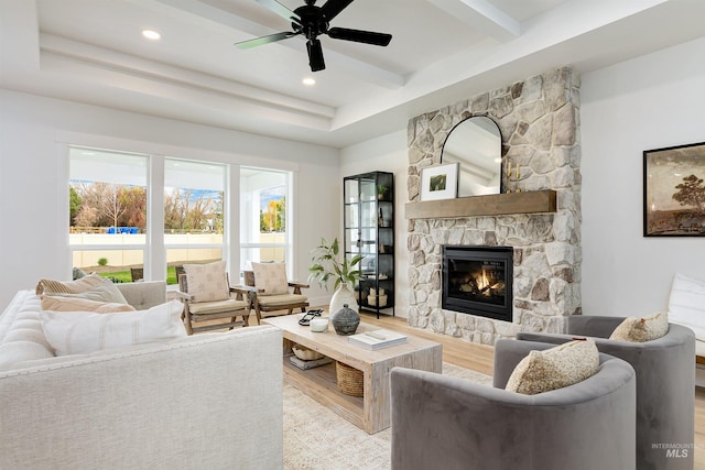 living room featuring beamed ceiling, recessed lighting, a fireplace, and wood finished floors